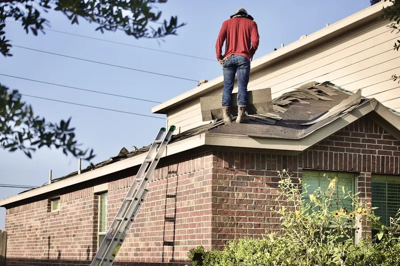 Professional roofer working on a residential roof in Ursina